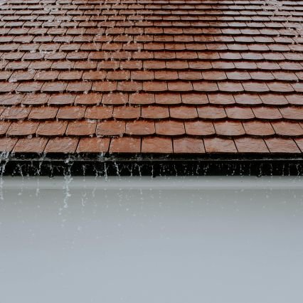 Rain pouring off house