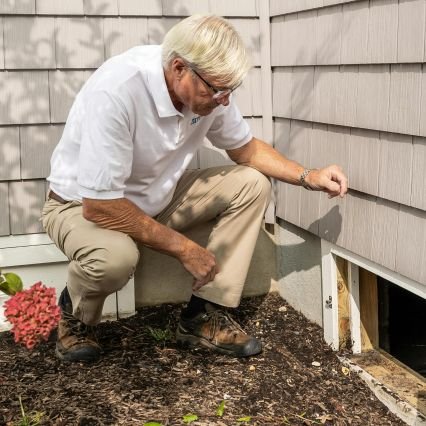 Man inspecting home foundation